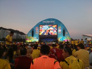 Fans without tickets watch the match on a video screen.