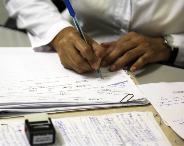 A doctor prepares her notes in Pernambuco, Brazil.