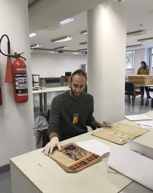Photo of Gabriel Lesser researching 20th century humor magazines