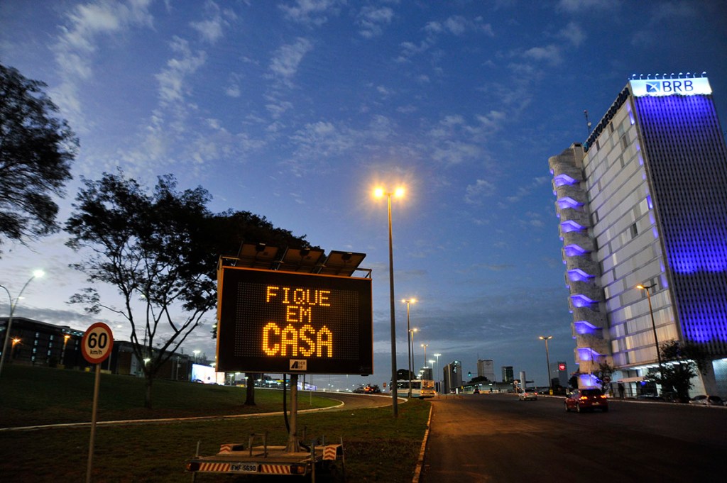 A sign warns residents of Brasília, "Stay at home." 