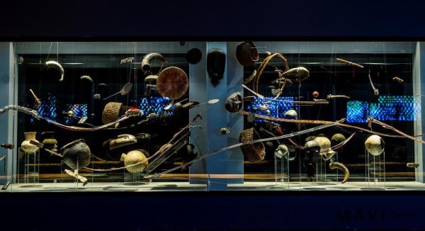 A display of artifacts in a glass case, from an exhibition by artist Francisco Huichaqueo.