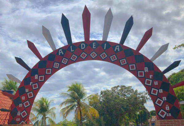 A colorful arch forms the gateway to an Indigenous aldeia in Araunã, Brazil.