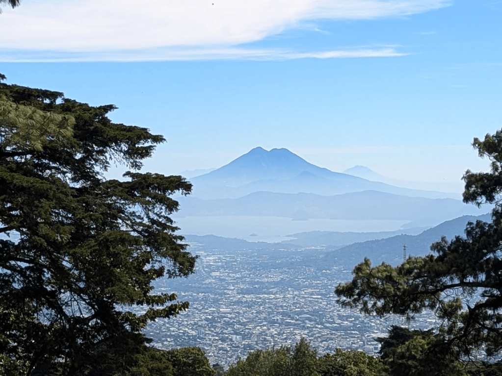View from Parque Nacional El Boquerón, with a volcano looming behind the cityscape of San Salvador.