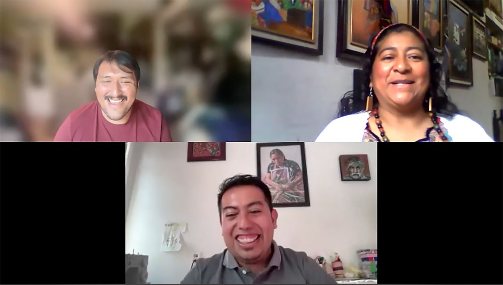 Three speakers in a video conference: two man, one in a red shirt and the other in green, and a woman wearing a white sweater over a colorful top.