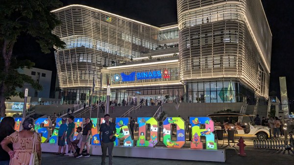 The modern National Library of El Salvador in San Salvador, with a bright and colorful lighted sign reading El Salvador.