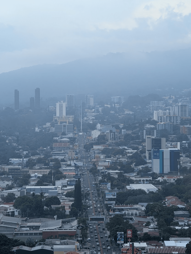 A smoggy cityscape and skyline, looking out over San Salvador.